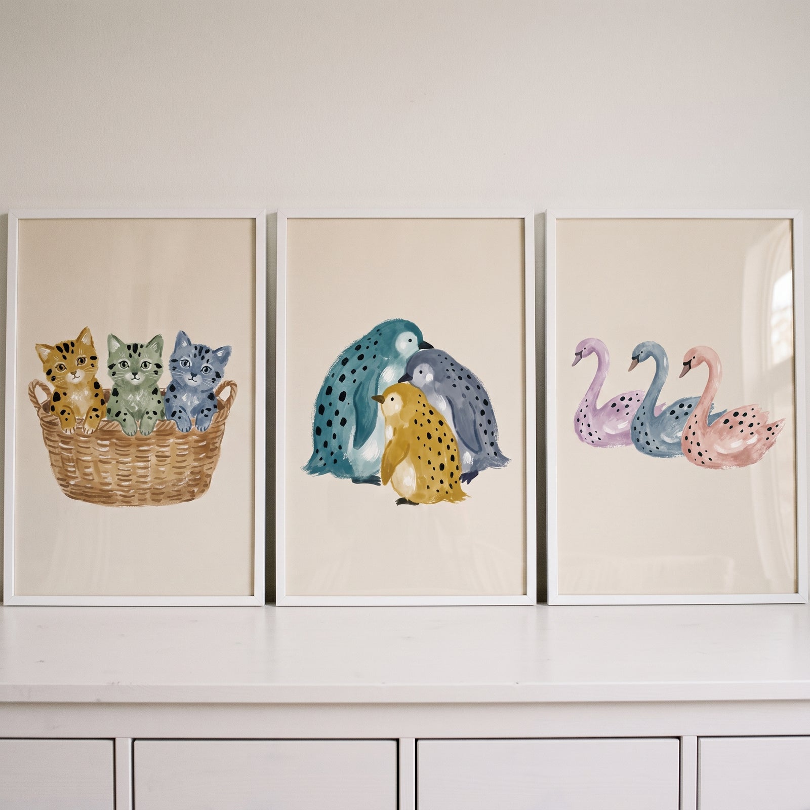 Muted tone spotted animal wall art set of 3 featuring kittens in a basket, penguins, and swans.