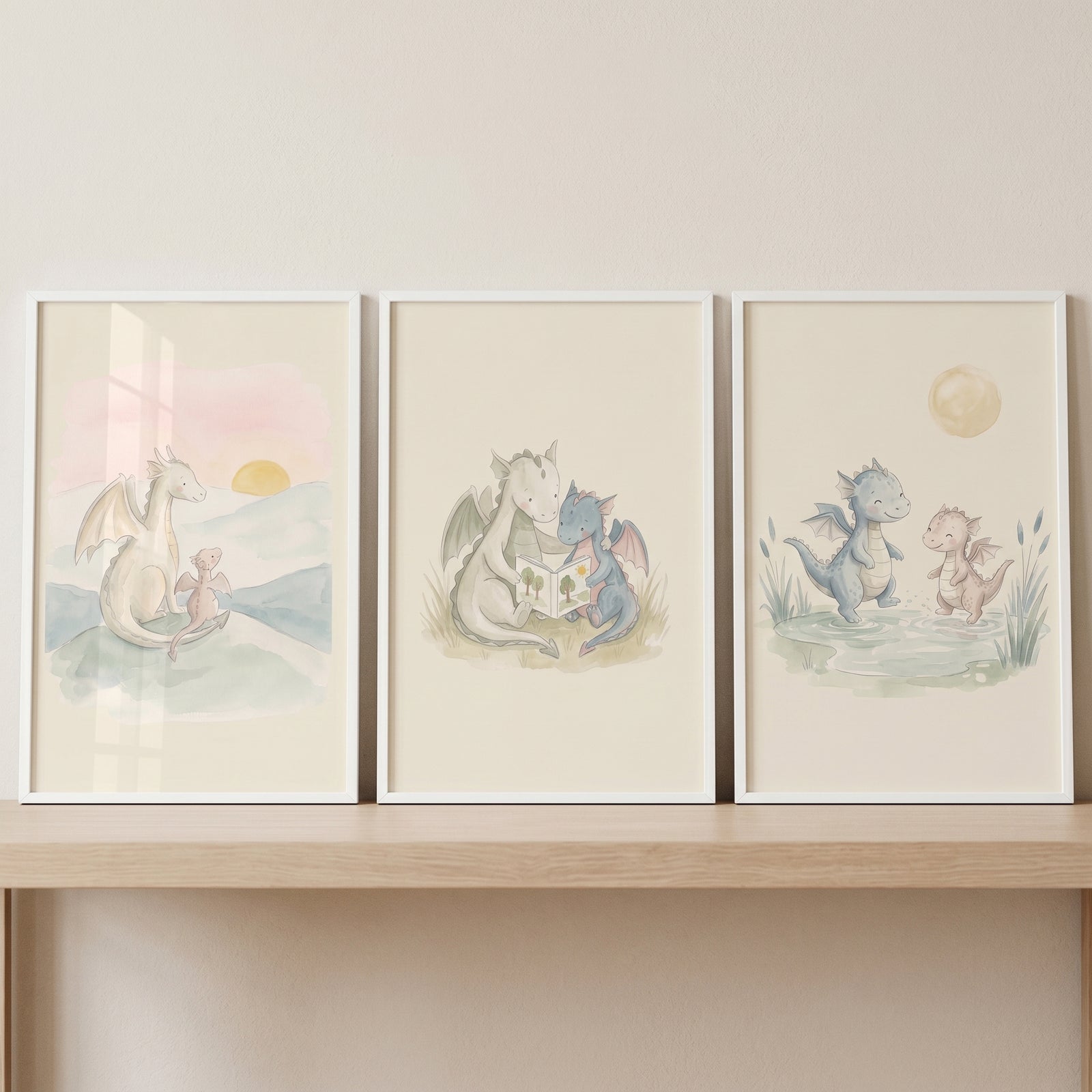 Muted wash baby dragons wall art set of 3 depicts cute dragons reading, playing near water, and watching a sunset.