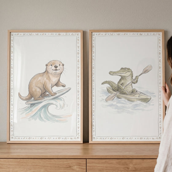 Otter surfing and a crocodile kayaking in this muted watercolor aquatic animals wall art set of 2.