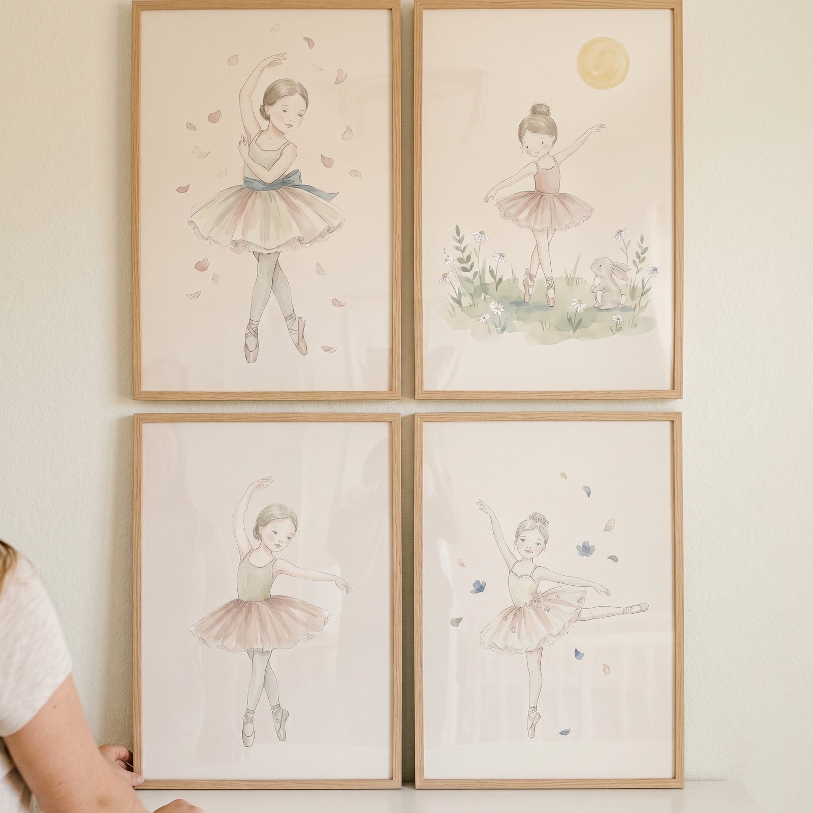 Muted watercolor tutu ballerina wall art set of 4 in wooden frames featuring young girls in elegant dance poses.