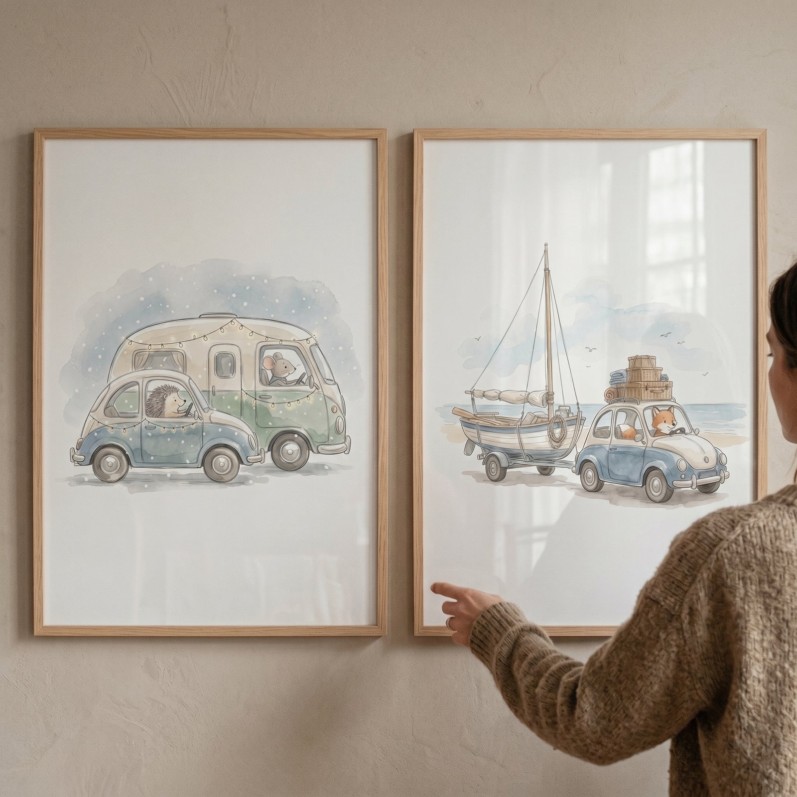 A person touches a muted watercolor voyager animals wall art set of 2 featuring creatures in vintage vehicles and a boat.