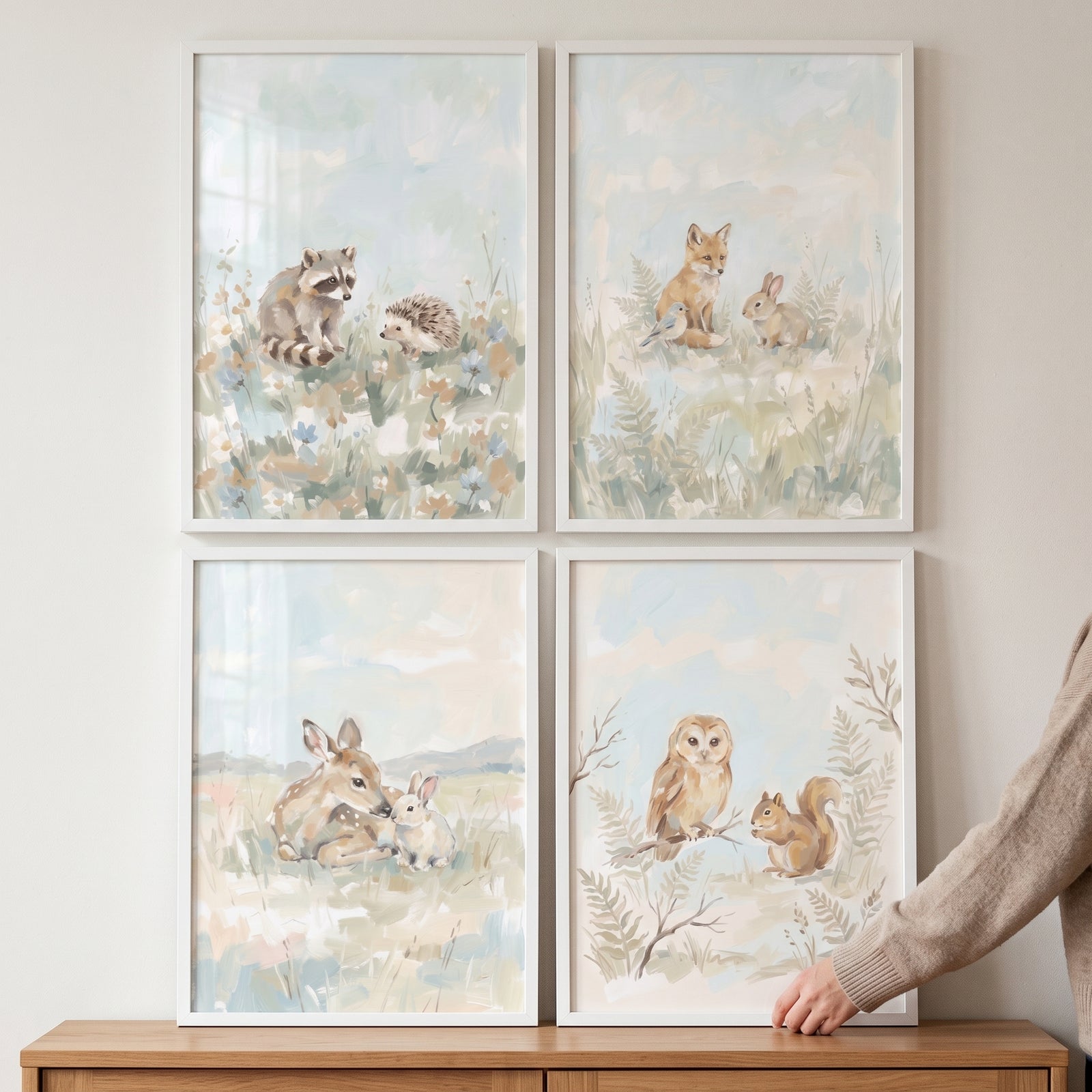 Muted watercolor woodland animals wall art set of 4 featuring forest creatures in white frames on a wall.