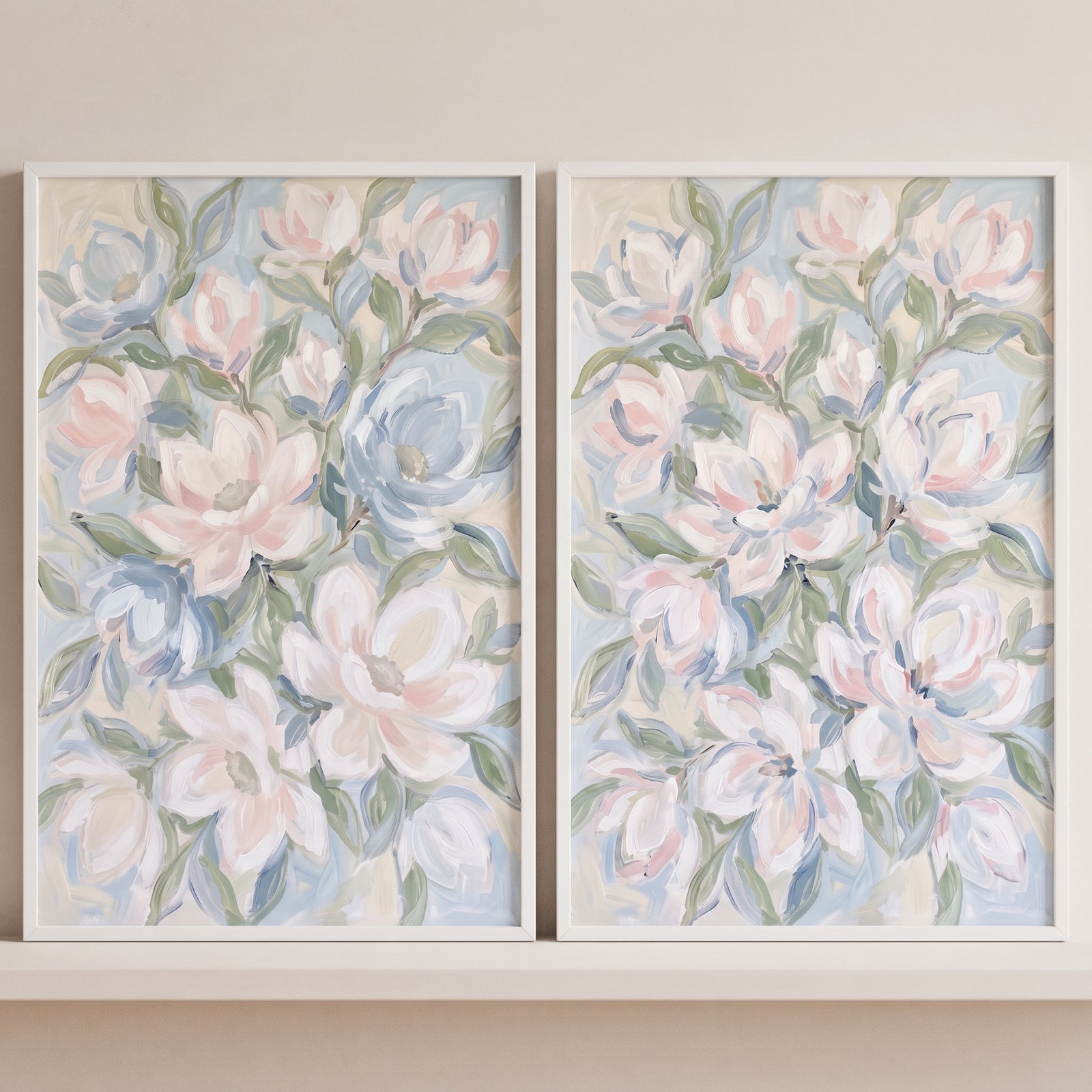 Muted white magnolia floral wall art set of 2 features soft pastel blossoms and green leaves in thin white frames.