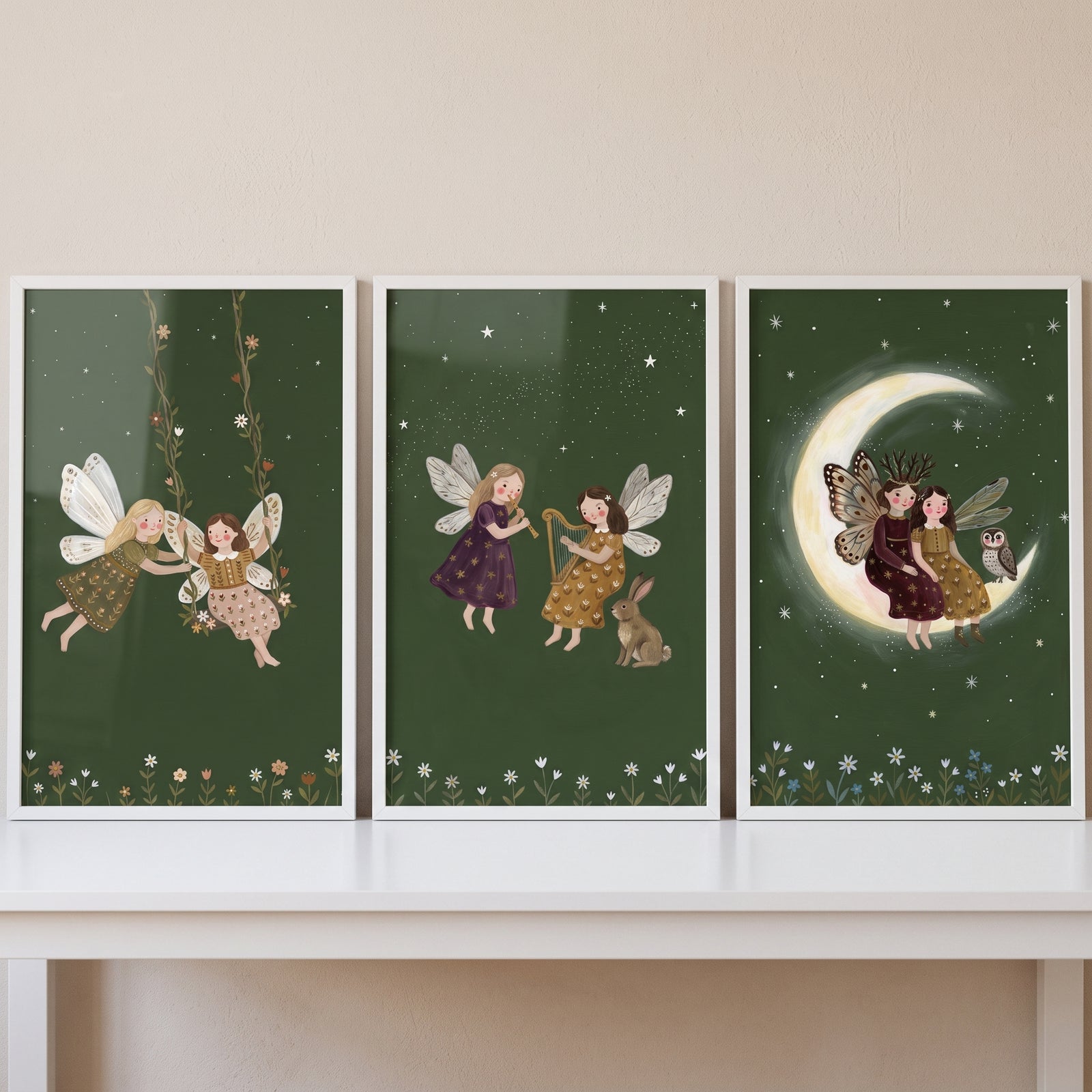 Mystical winged garden fairies wall art set of 3 featuring fairies swinging, playing music, and on a crescent moon.