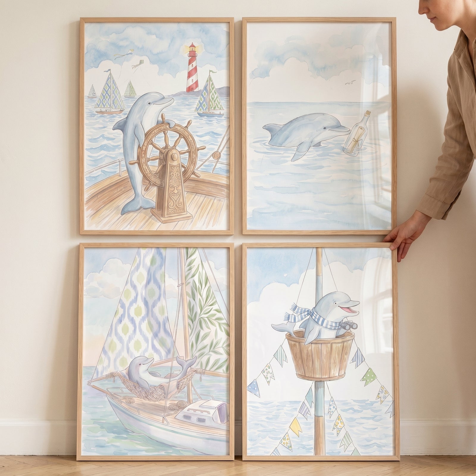 Nautical blue dolphin wall art set of 4 features watercolor illustrations of dolphins sailing and swimming at sea.