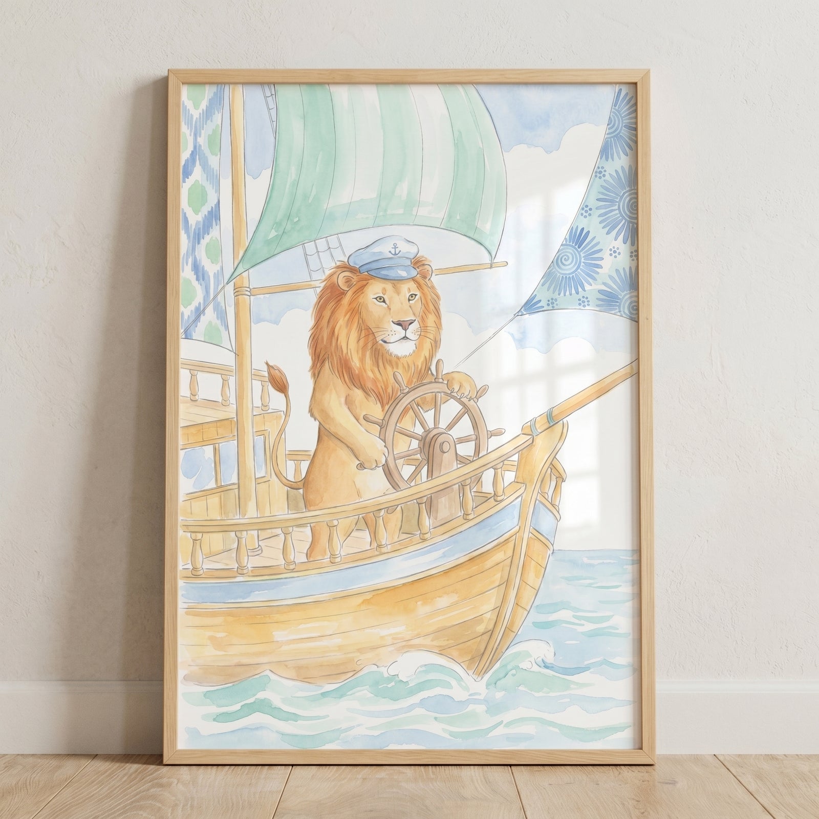 Nautical captain lion wall art with a watercolor lion wearing a hat and steering a wooden ship on blue ocean waves.