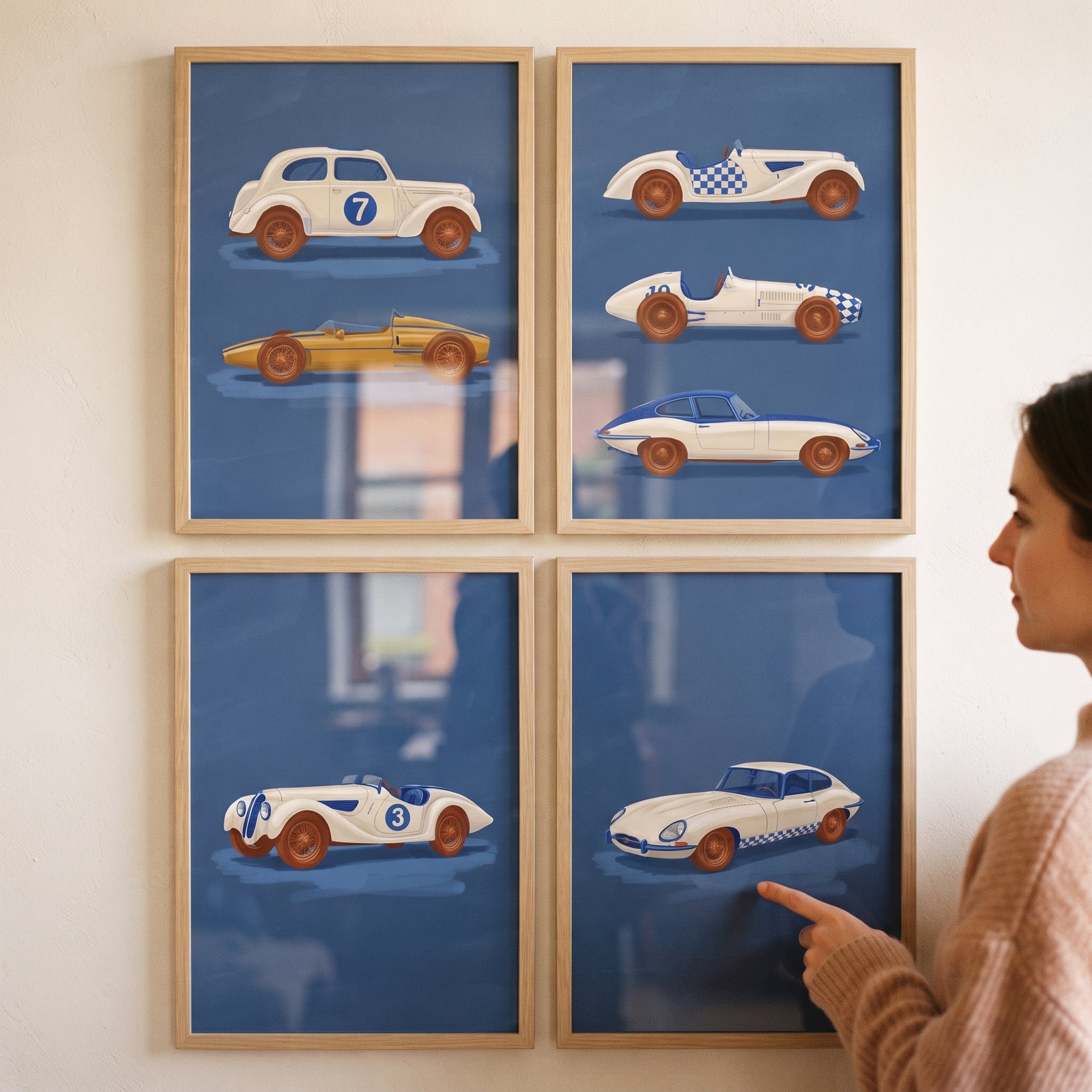 Nautical navy vintage car wall art set of 4 in wood frames on a wall as a person points to a classic car.