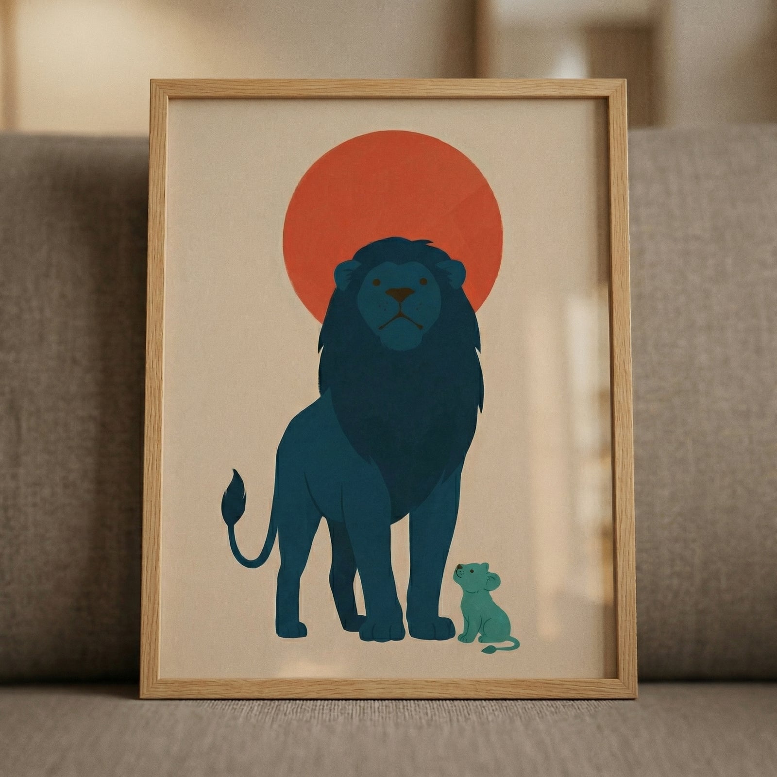 Framed illustration of a blue lion standing tall with a small cub beside it under a bold red sun. The simple shapes and warm tones create a calm and reassuring focal point for a nursery or cozy room.