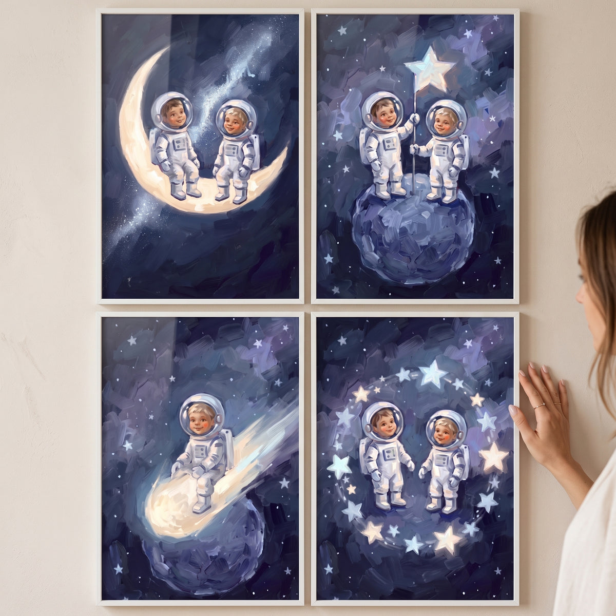Navy galaxy baby astronaut wall art set of 4 features toddlers in spacesuits on a crescent moon and among bright stars.