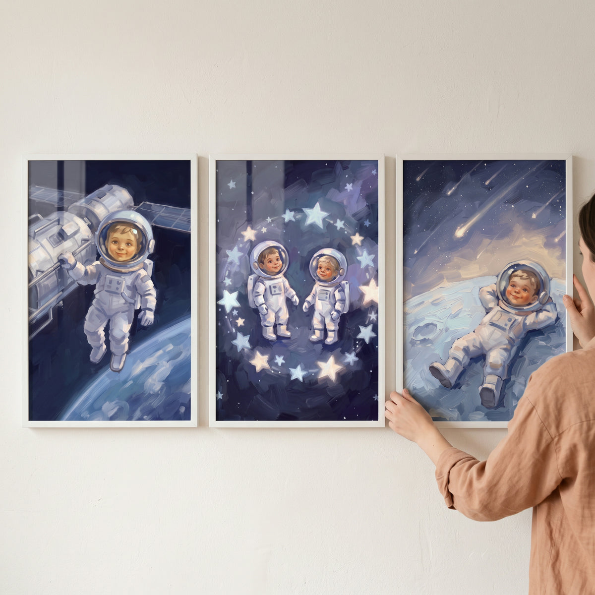 Navy suit baby astronaut wall art set of 3 features infants in space gear exploring the stars and planets.