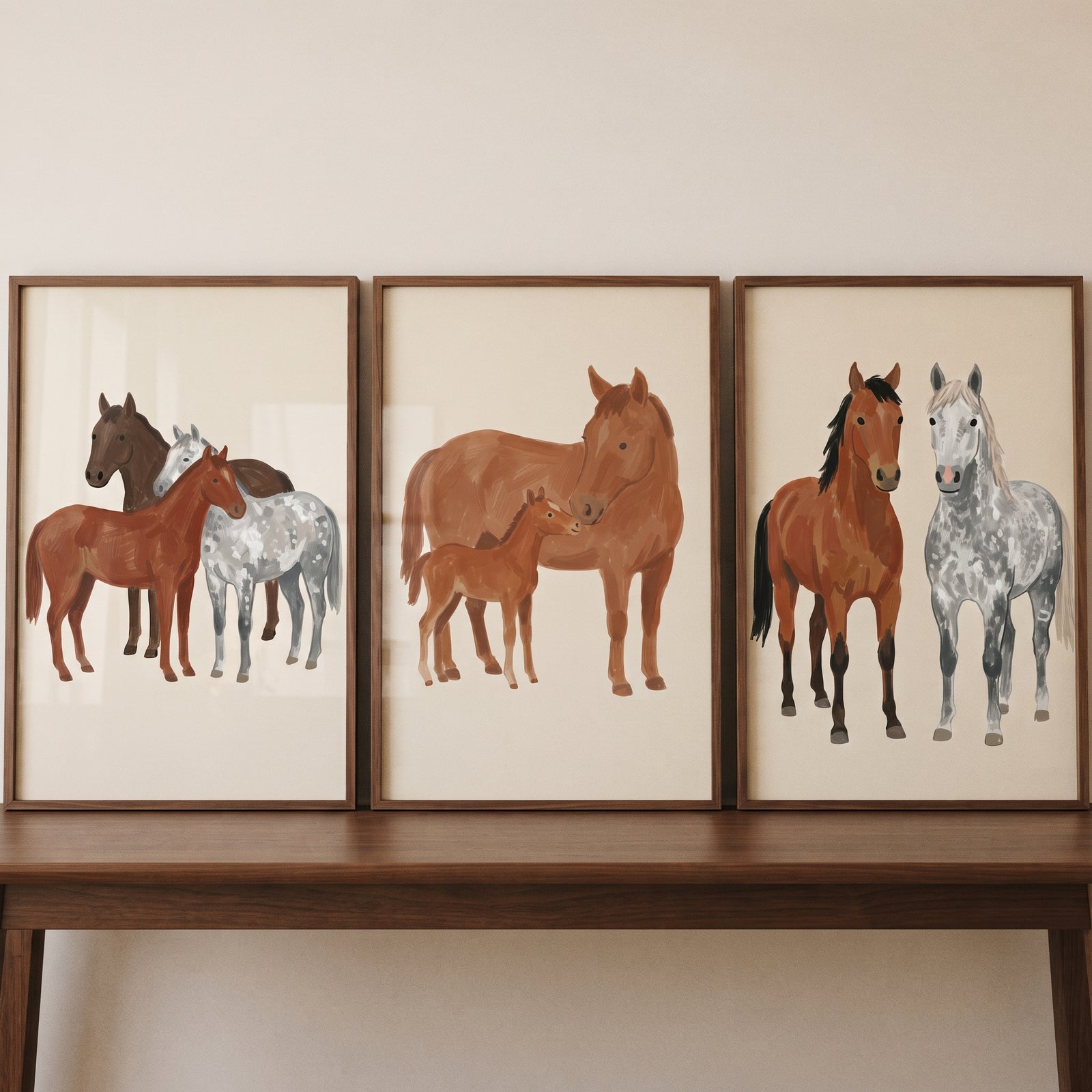 Neutral brown horse wall art set of 3 on a wooden table, featuring horse drawings in muted colors.