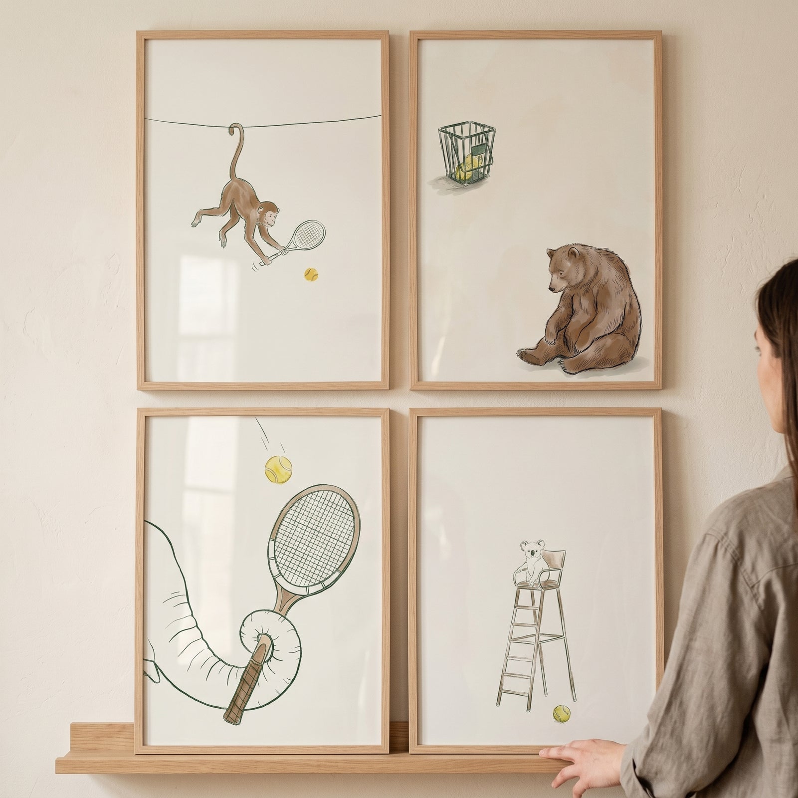 Neutral cream tennis animal wall art set of 4 featuring a monkey, bear, elephant trunk, and koala in light wood frames.