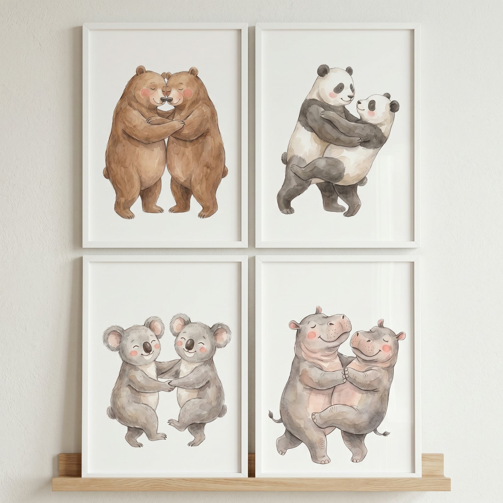 Neutral hugging animals wall art set of 4 features framed illustrations of bears, pandas, koalas, and hippos.