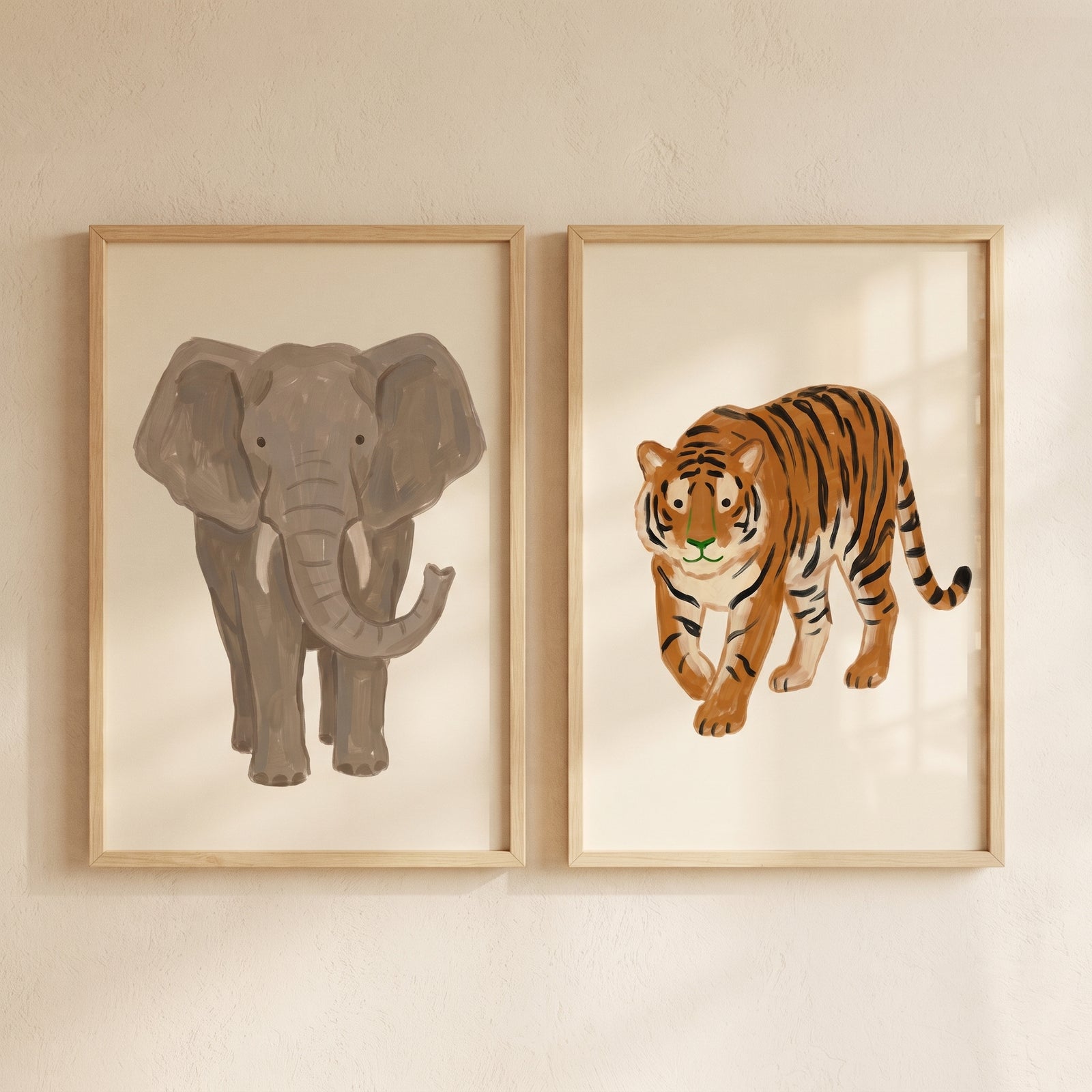 Neutral safari animals wall art set of 2 featuring a grey elephant and orange tiger in light wood frames.