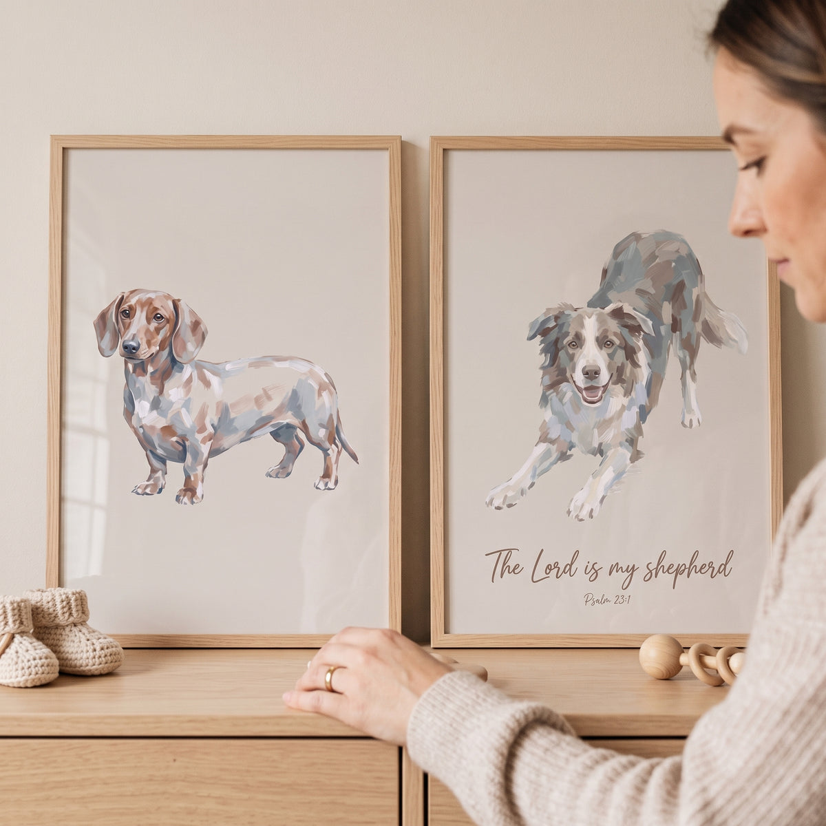 Neutral tan watercolor dog wall art set of 2 featuring a dachshund and border collie in wooden frames on a dresser.