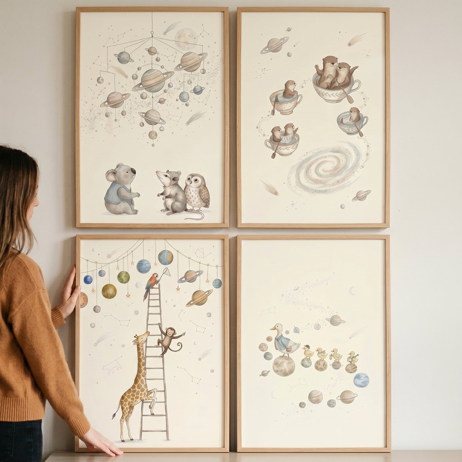 A woman displays a neutral tones celestial animal wall art set of 4 featuring whimsical space-themed animal illustrations.