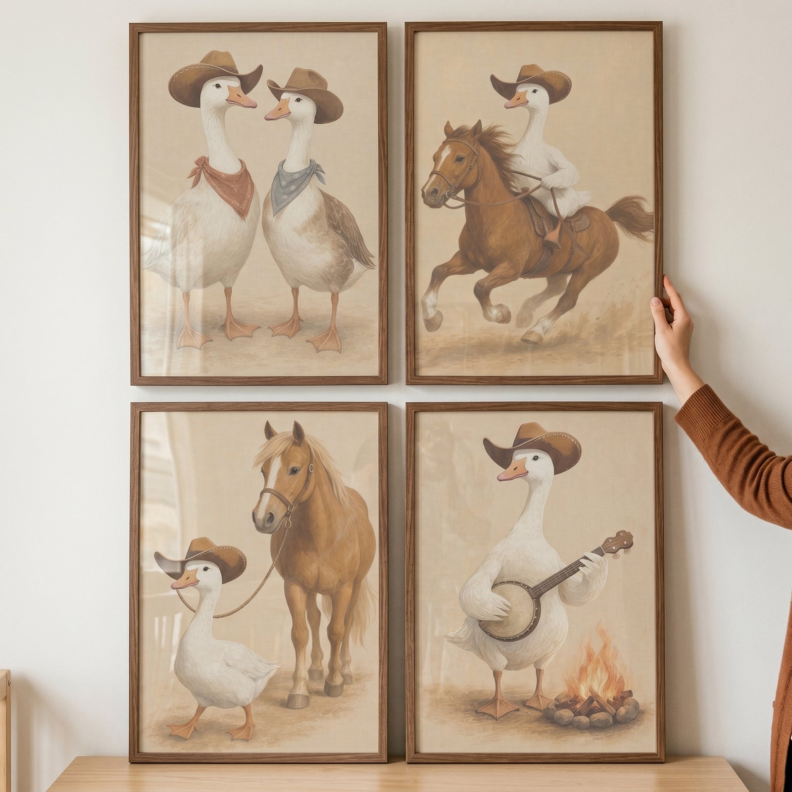 Neutral tones cowboy goose wall art set of 4 with geese in western hats riding horses and playing a banjo by a fire.