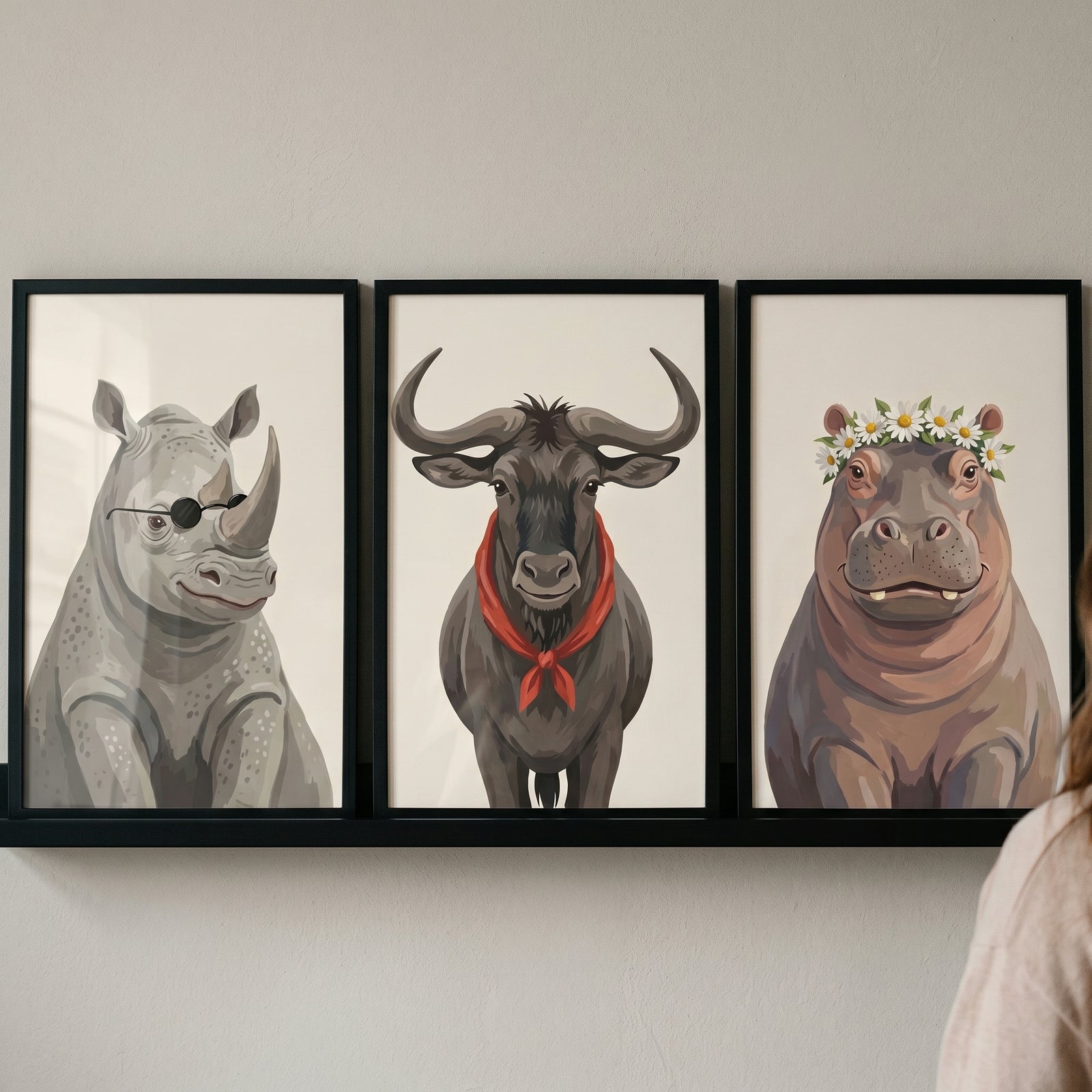 Neutral tones safari animals wall art set of 3 with a rhino in sunglasses, wildebeest in scarf, and hippo in flower crown.