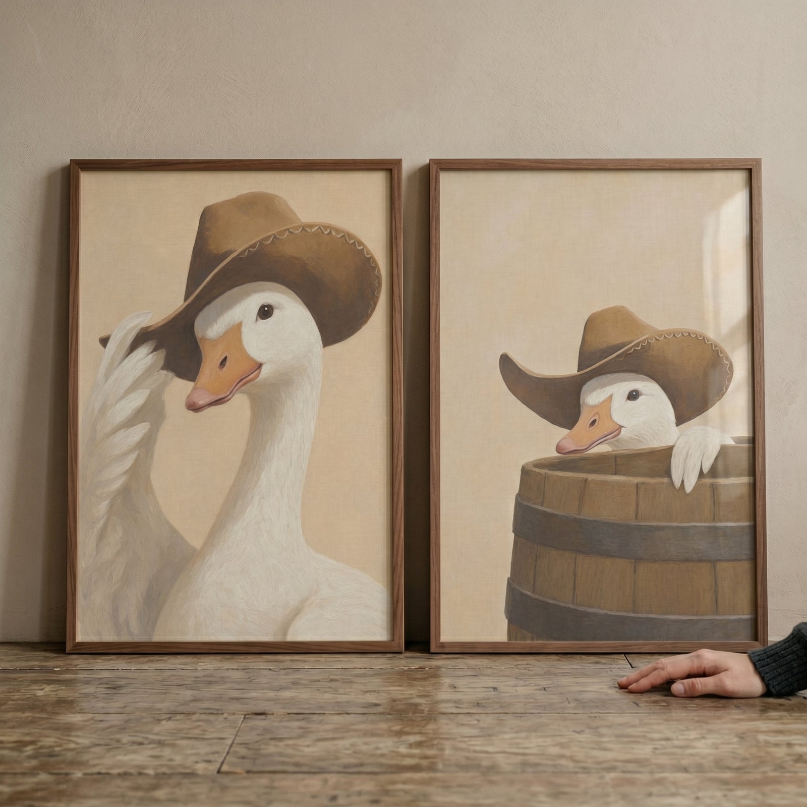 Neutral tones western goose wall art set of 2 featuring geese in cowboy hats, one tipping its hat and one in a barrel.