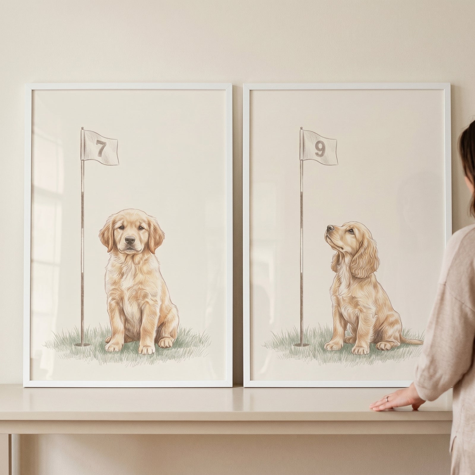 Neutral watercolor golf puppy wall art set of 2 depicting golden puppies sitting beside numbered golf flags.