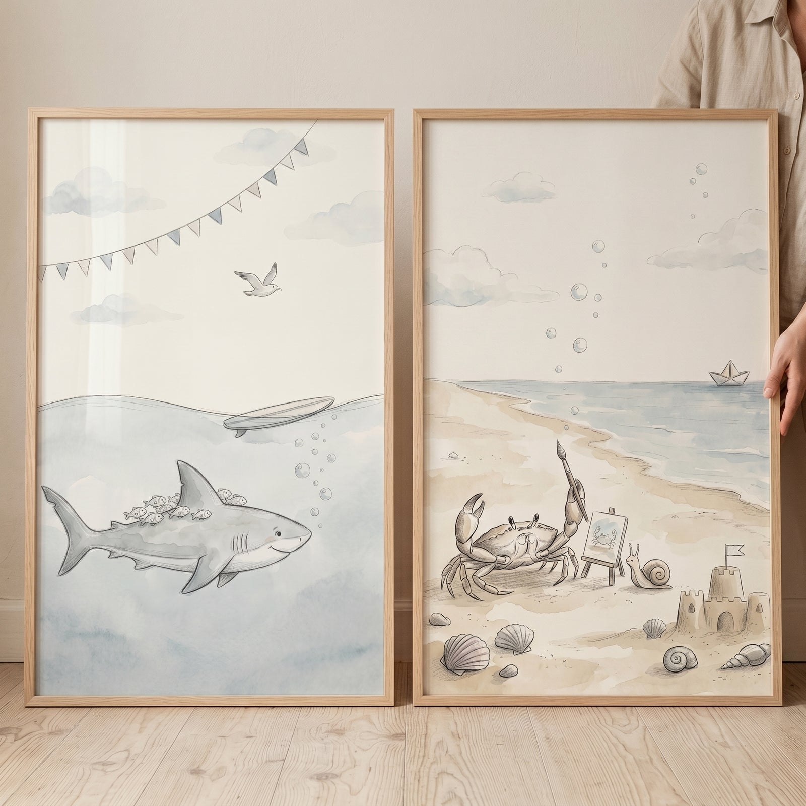 Neutral watercolor ocean animal wall art set of 2 featuring a shark underwater and a crab on a beach with a sandcastle.