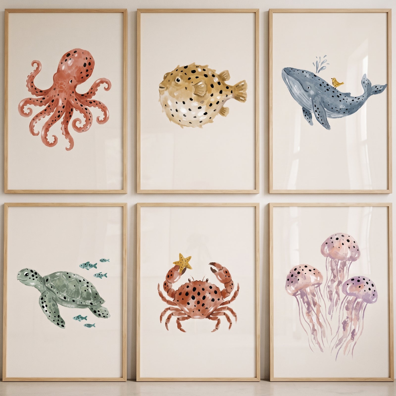 Neutral watercolor ocean animal wall art set of 6 featuring an octopus, pufferfish, whale, sea turtle, crab, and jellyfish.