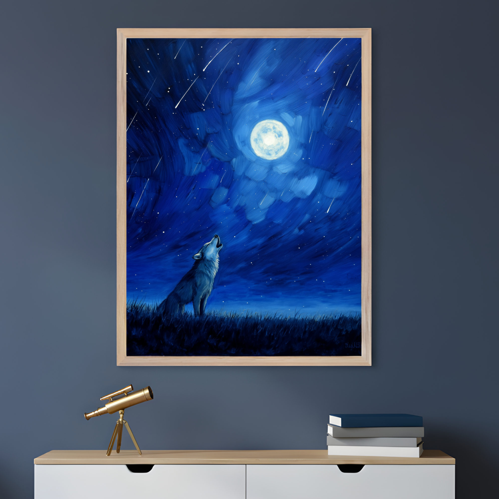 A framed painting depicts a lone wolf howling under a glowing full moon in a deep blue night sky filled with stars and streaking meteors. The dramatic brushstrokes create a sense of motion and wonder, complementing the dark-toned room where a small brass telescope and a stack of books rest on the cabinet below.