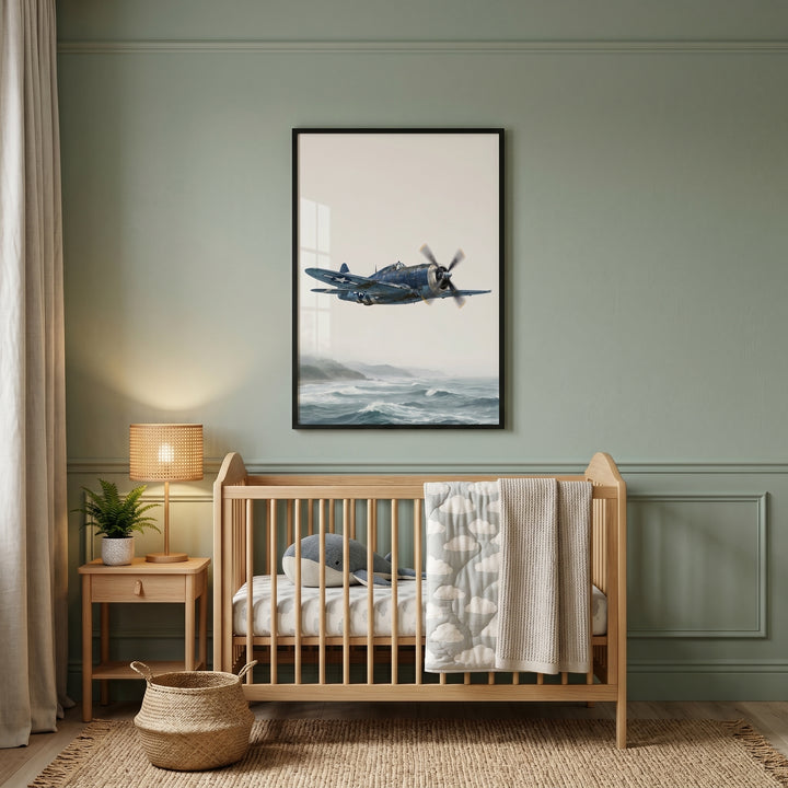 Ocean navy warbird wall art hangs over a wooden crib in a sage green nursery with a woven basket and side table lamp.