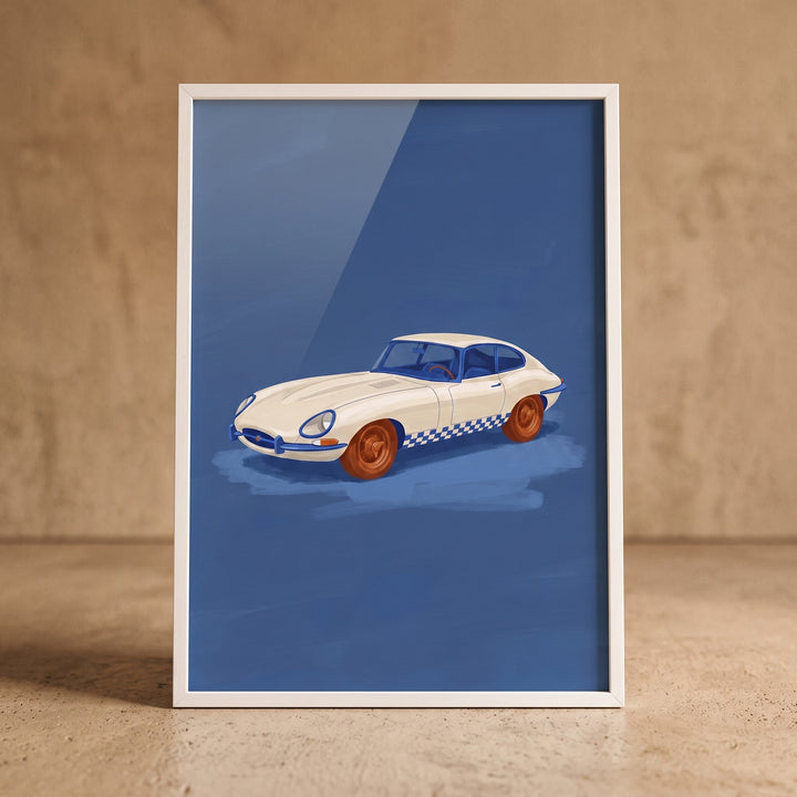 Off white checkered car wall art showing a vintage white vehicle with orange wheels against a blue backdrop in a frame.