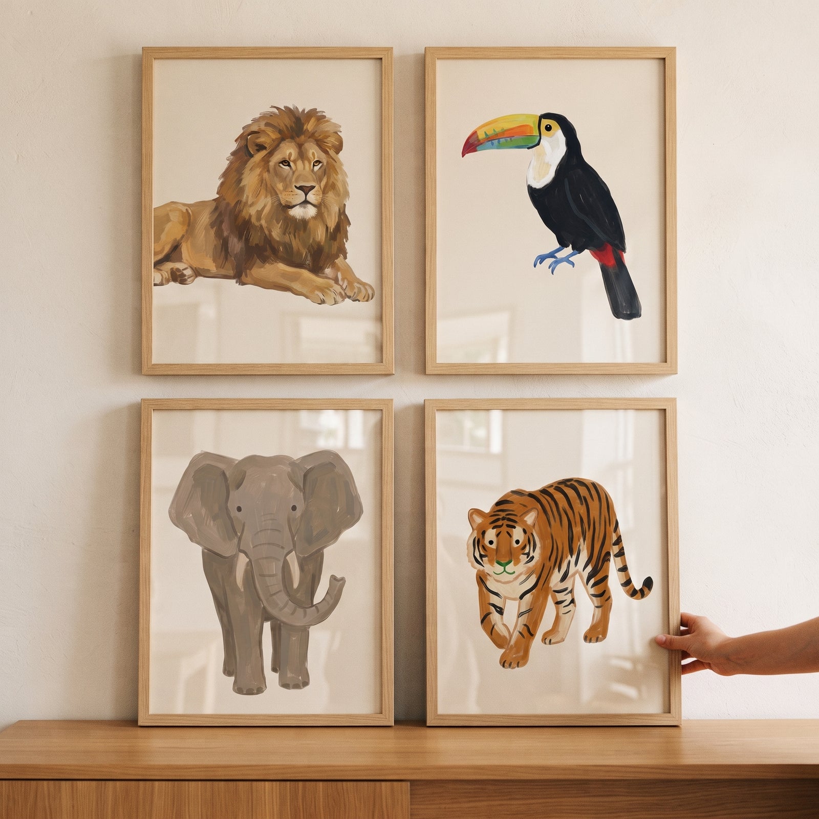 Organic earth tone animals artwork set of 4 featuring a lion, toucan, elephant, and tiger in light wood frames.