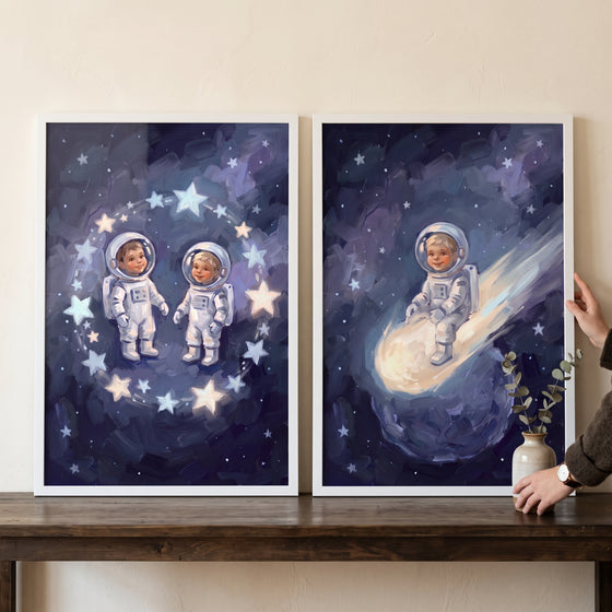 Outer space baby astronaut wall art set of 2 with infants in spacesuits among glowing stars and riding a bright comet.