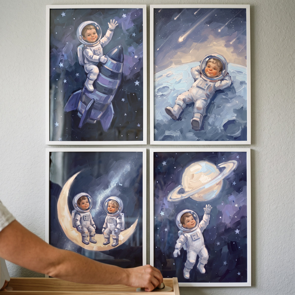 Painterly blue child astronaut wall art set of 4 featuring a child on a rocket, moons, and near a ringed planet.