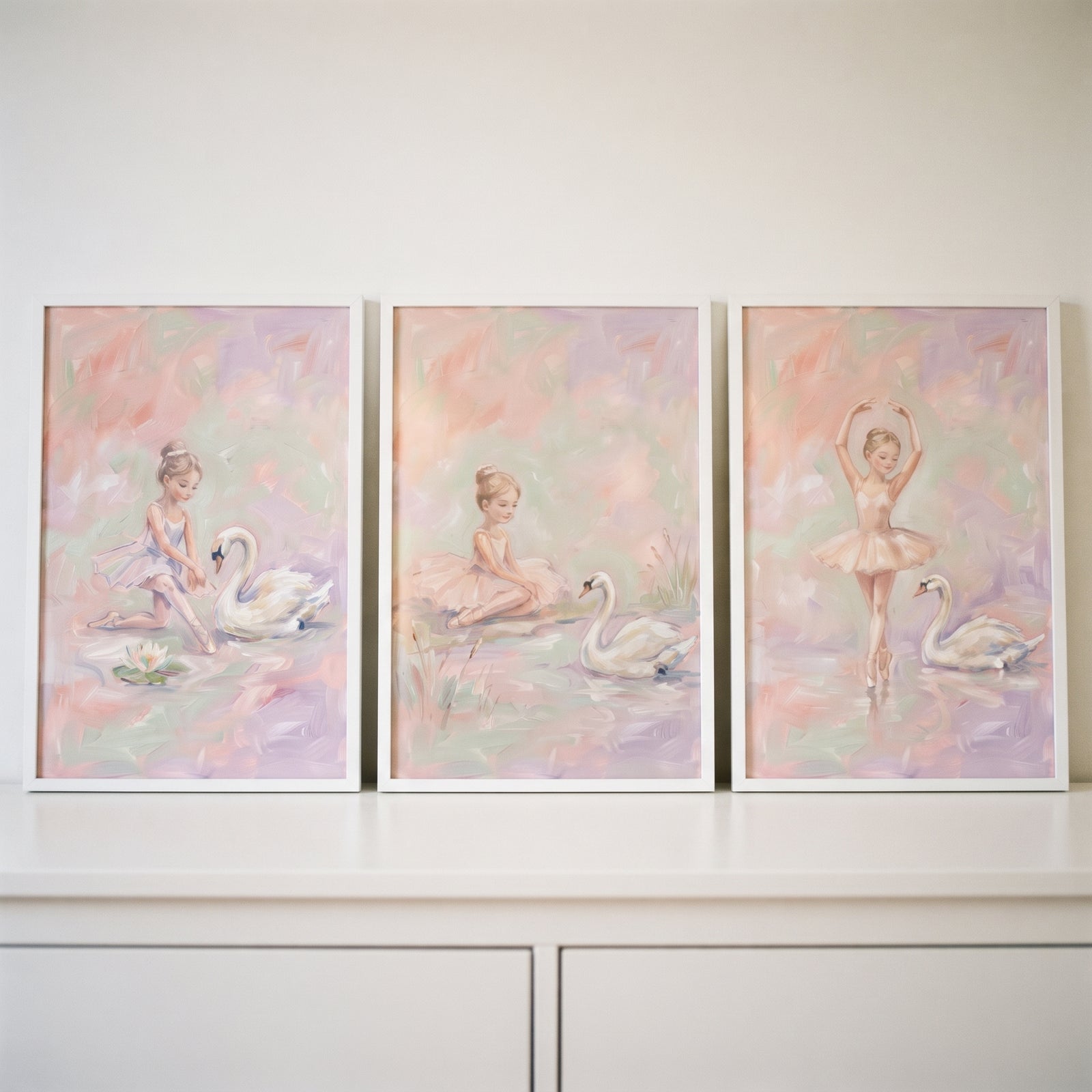Three ballerina and swan artworks in soft tones make up this painterly blush swan ballet wall art set of 3.