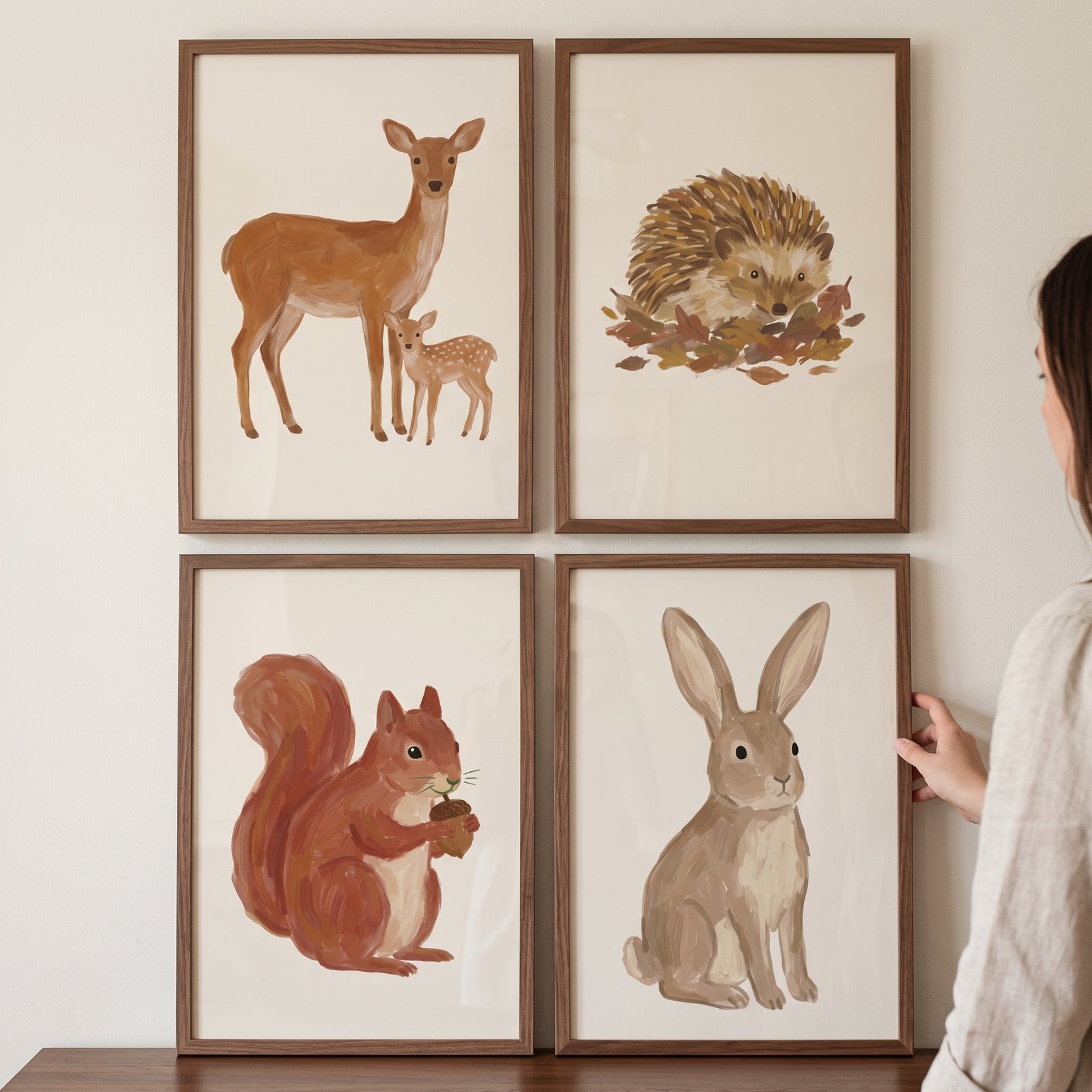 Painterly brown woodland animals wall art set of 4 featuring a deer, hedgehog, squirrel, and rabbit in wood frames.