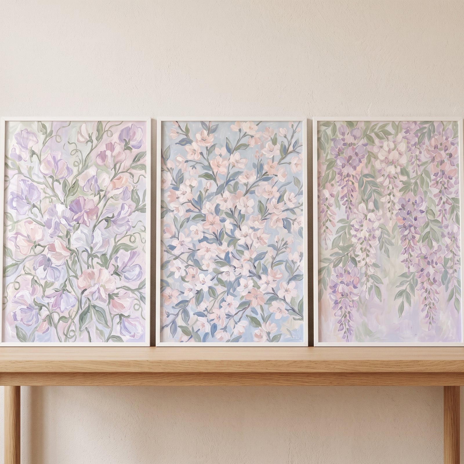 Painterly lavender botanical floral wall art set of 3 sits on a wooden console table against a soft beige wall.