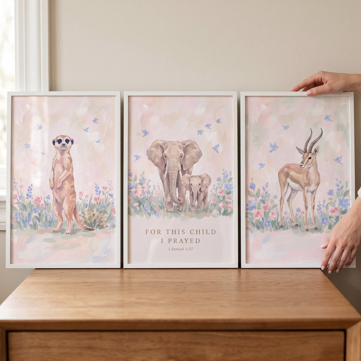 Painterly meadow savanna animals wall art set of 3 with a meerkat, elephants, and gazelle. Text says For this child I prayed.
