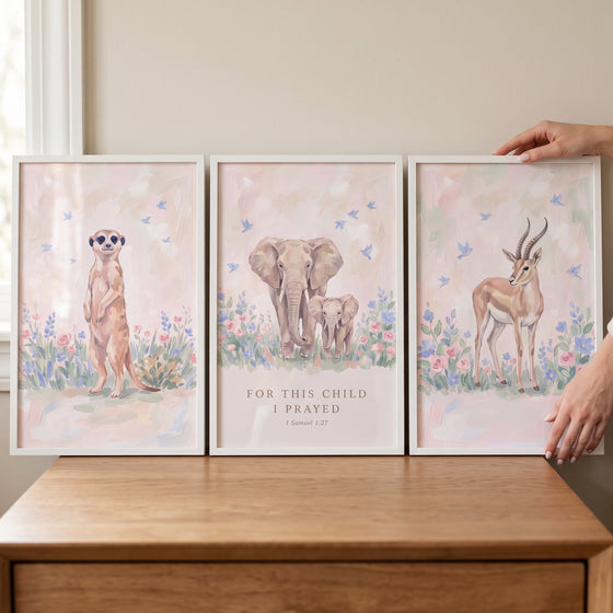 Painterly meadow savanna animals wall art set of 3 with a meerkat, elephants, and gazelle. Text says For this child I prayed.