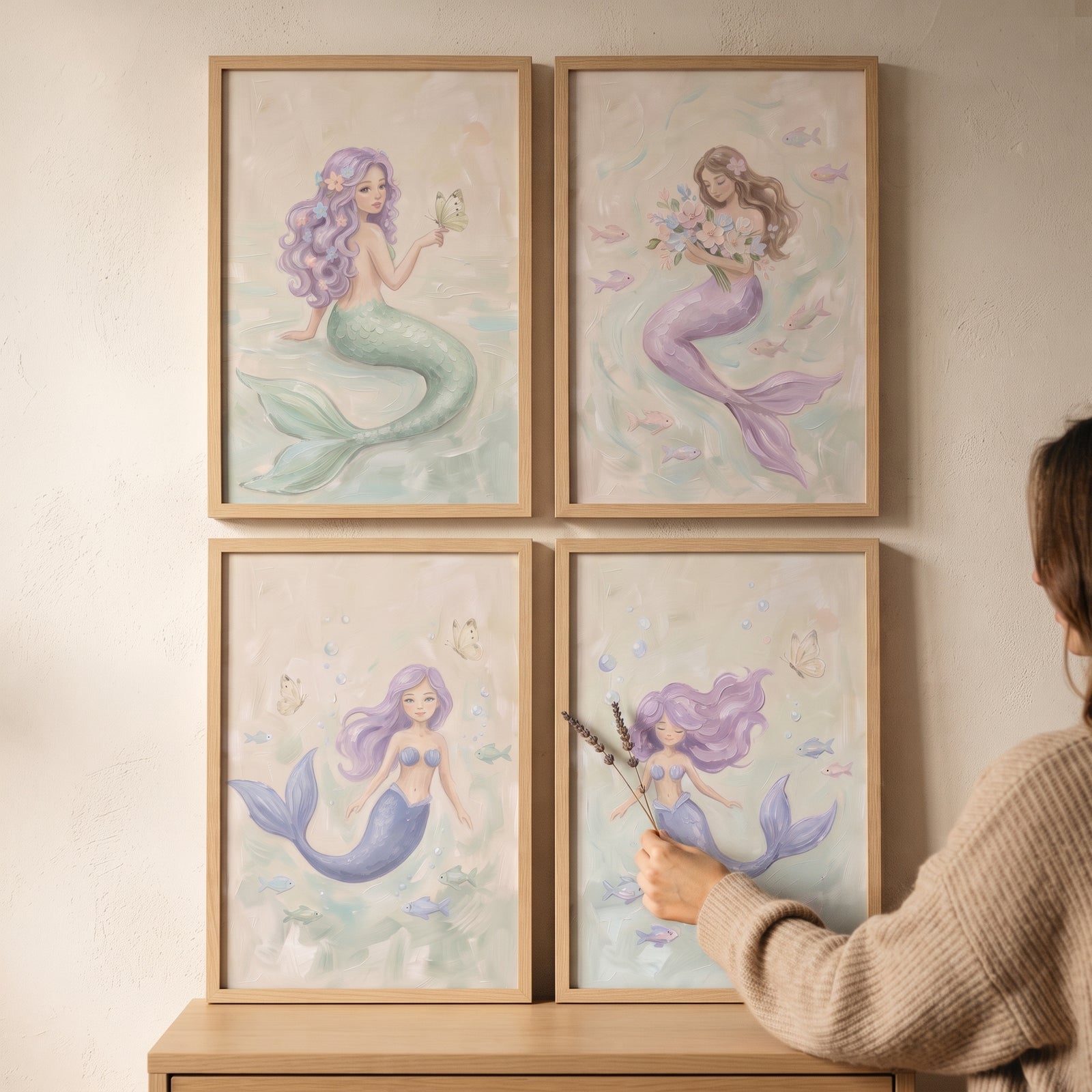 Painterly soft pastel mermaid wall art set of 4 in wooden frames hangs on a neutral wall.