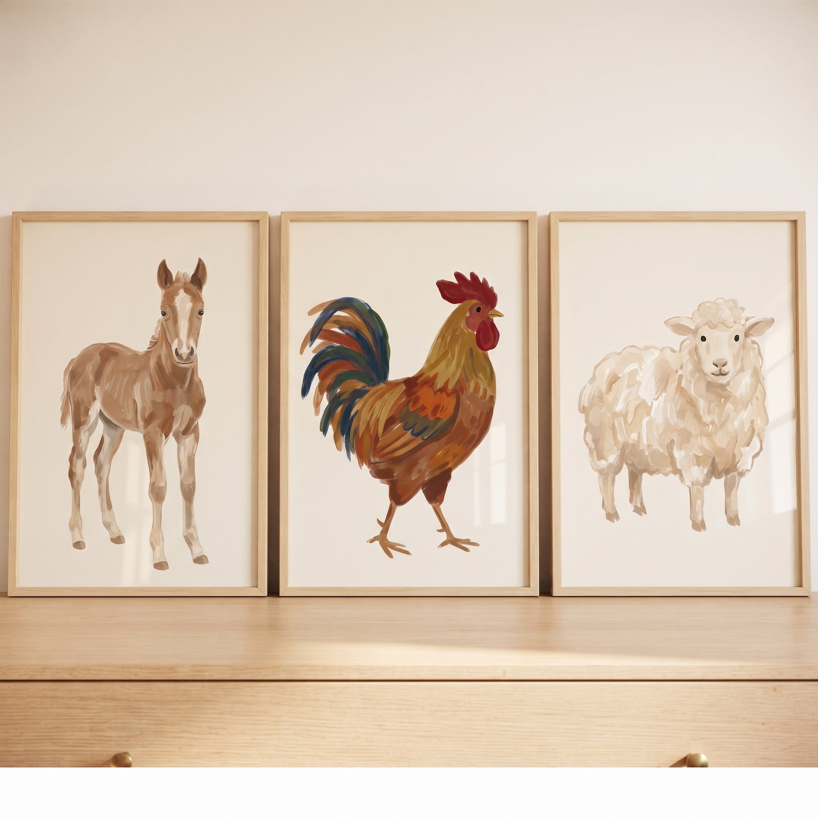 Painterly tan farm animals wall art set of 3 features a brown horse, a rooster, and a sheep in wooden frames.