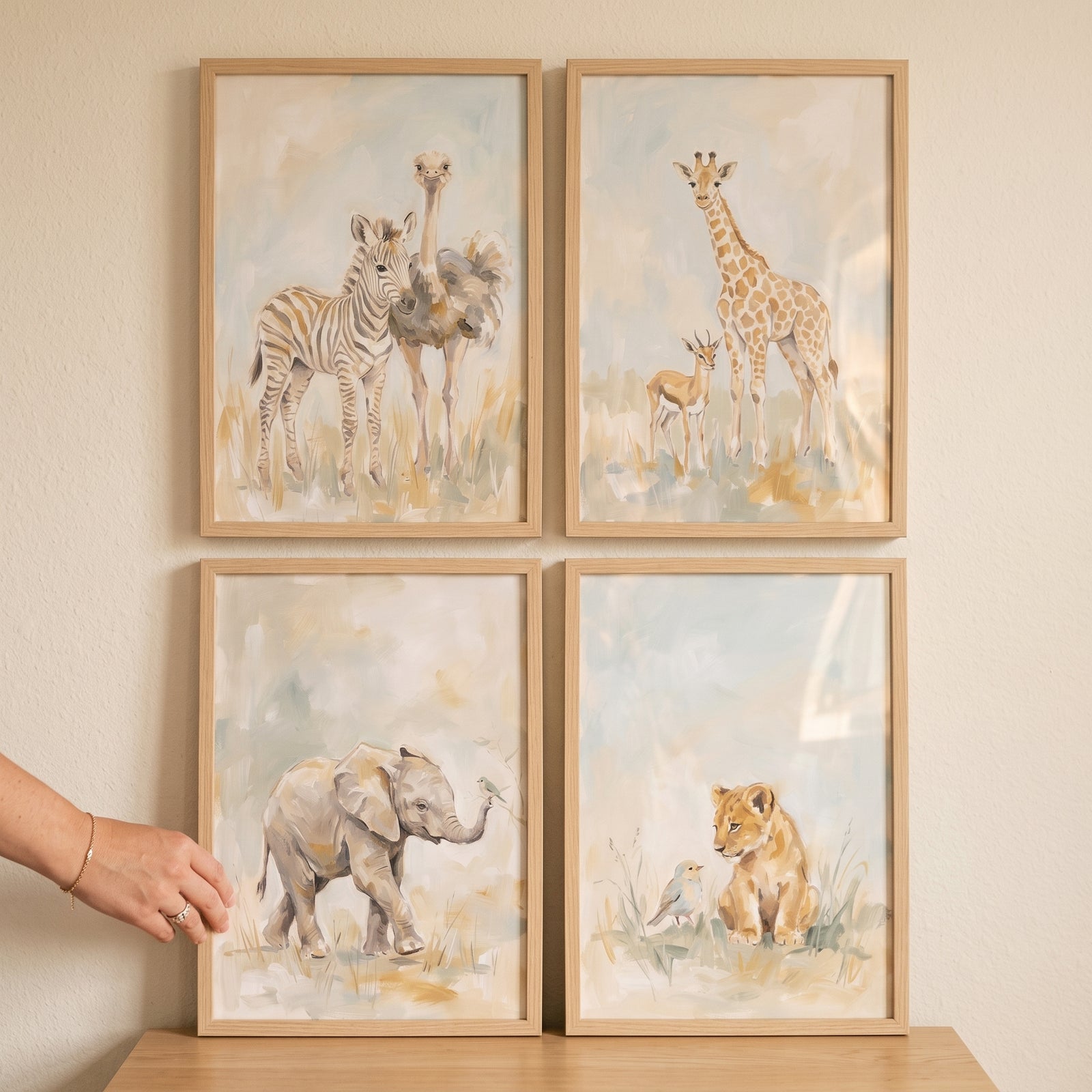 Pale blue safari animals wall art set of 4 featuring a zebra, ostrich, giraffe, antelope, elephant, and lion in wood frames.