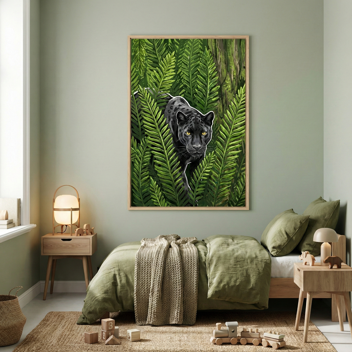 A cozy child's bedroom features a large piece of artwork framed in light wood on a sage green wall. The artwork depicts a sleek black jungle cat with glowing yellow eyes peering through dense green fern leaves. Below, a low wooden bed is dressed in olive green linens and a beige textured throw. Two simple wooden nightstands flank the bed, each holding a warm lamp. A natural fiber rug covers the floor, where a wooden toy train and blocks are scattered, creating a serene and playful atmosphere.