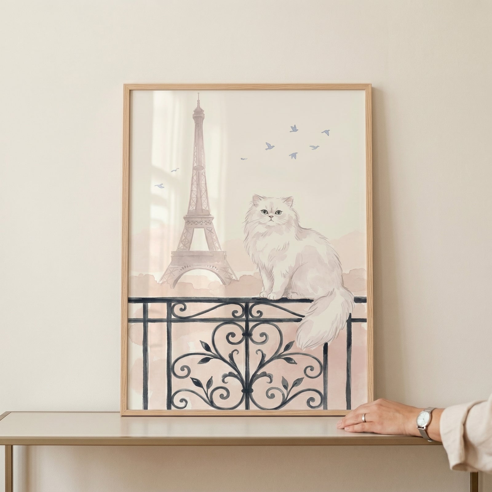 Framed paris balcony white cat wall art shows a fluffy pet on a decorative railing with a tall tower and birds.