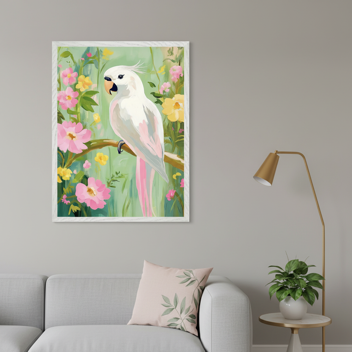 Modern living room with a light gray sofa. A large framed painting of a white cockatoo on a branch among pink and yellow flowers, in a vibrant, illustrative style, hangs above the left side of the sofa. A brass floor lamp and a potted plant on an end table are on the right.