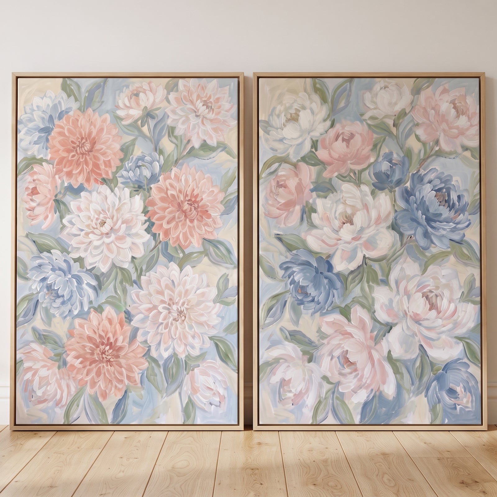 Pastel blue dahlia floral wall art set of 2 features pink and blue flowers in wood frames on a light wood floor.