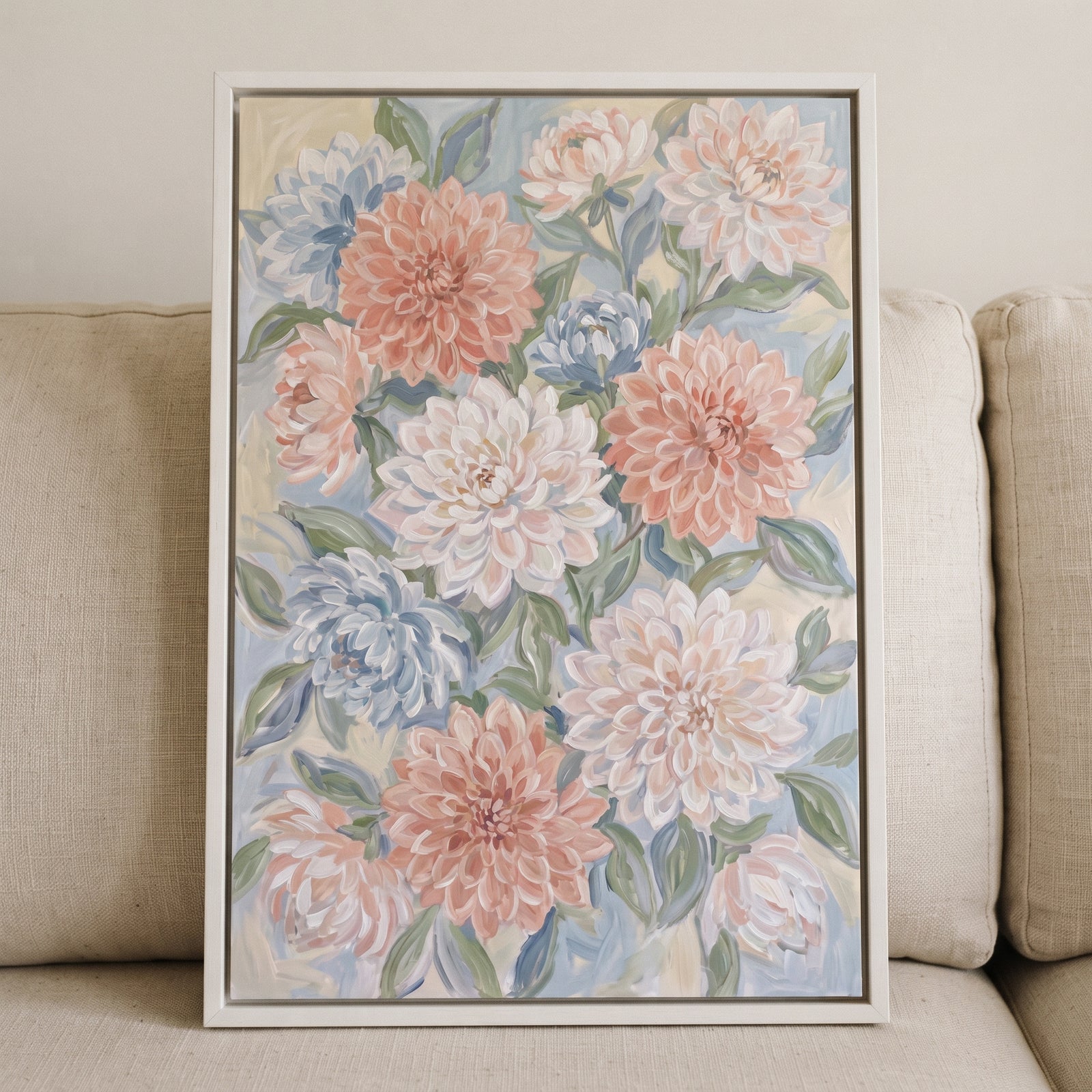 Framed pastel blush pink dahlia floral wall art with blue, white, and peach blossoms and green leaves.