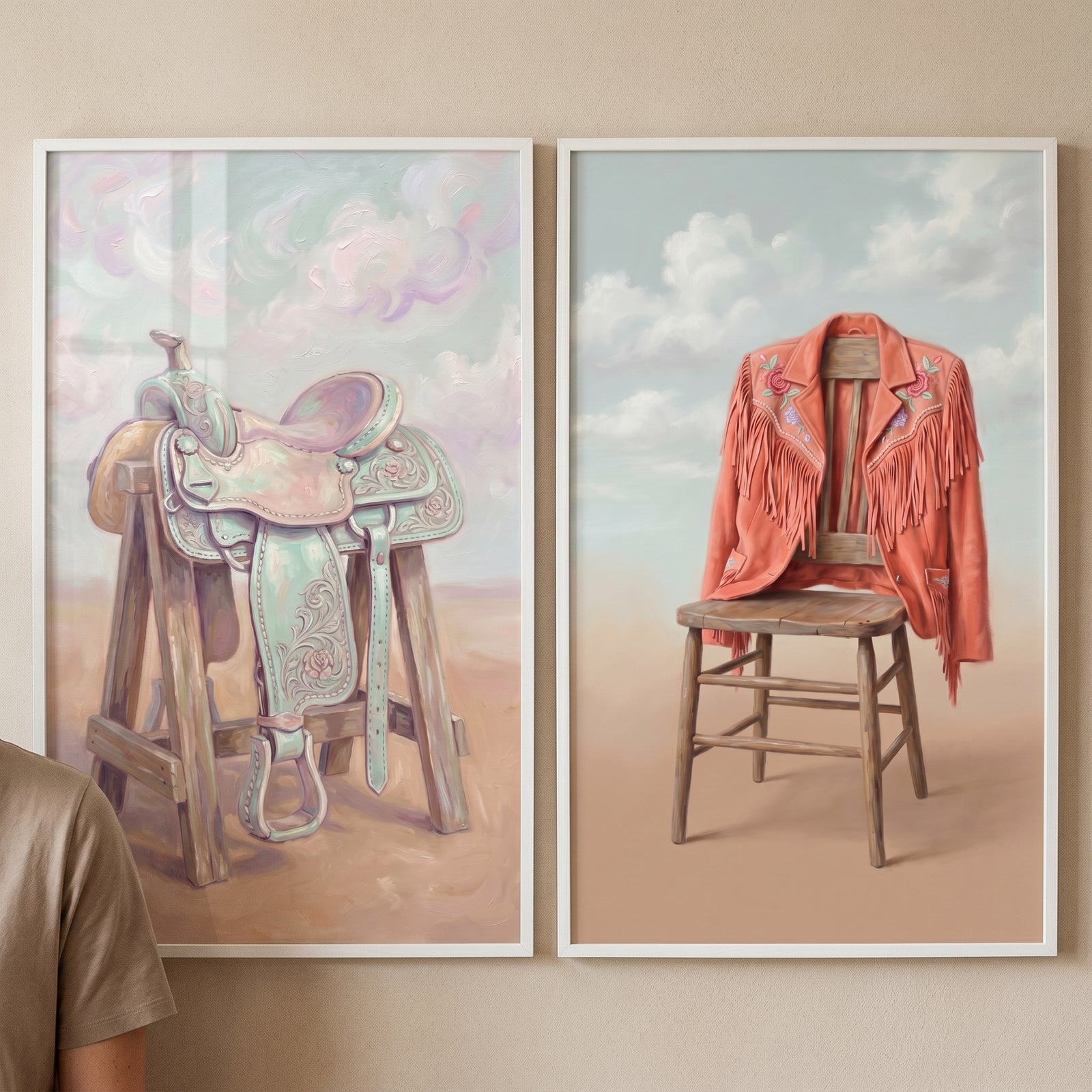 Pastel dreamy desert western wall art set of 2 featuring a saddle on a stand and a fringed jacket on a wooden chair.