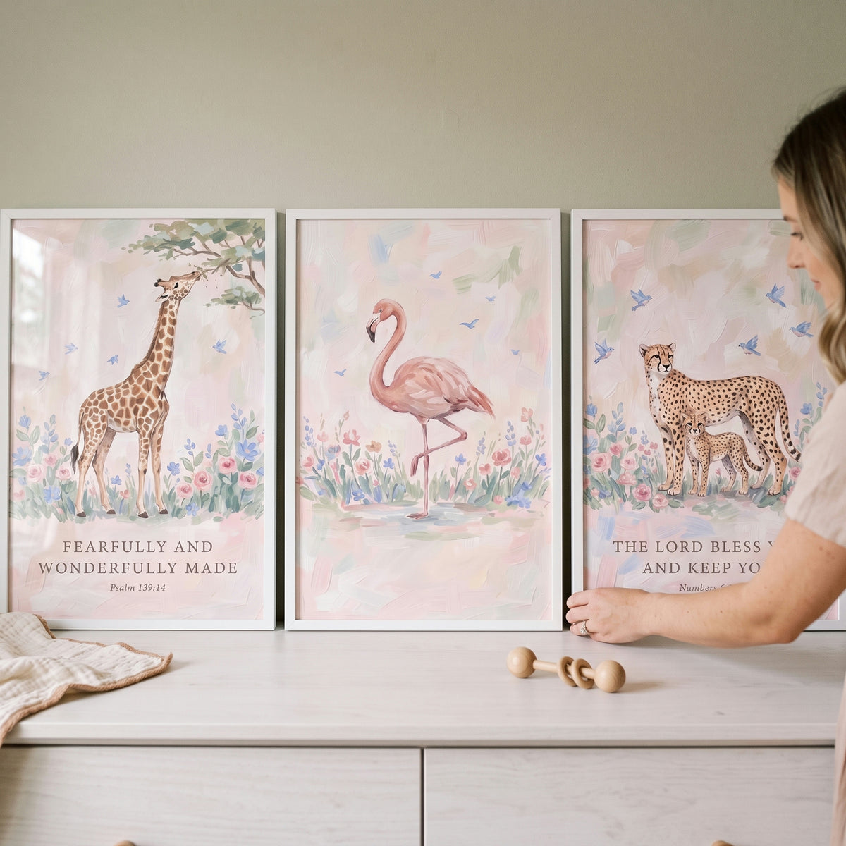 Pastel garden safari animals wall art set of 3 featuring a giraffe, flamingo, and cheetah on a white nursery dresser.