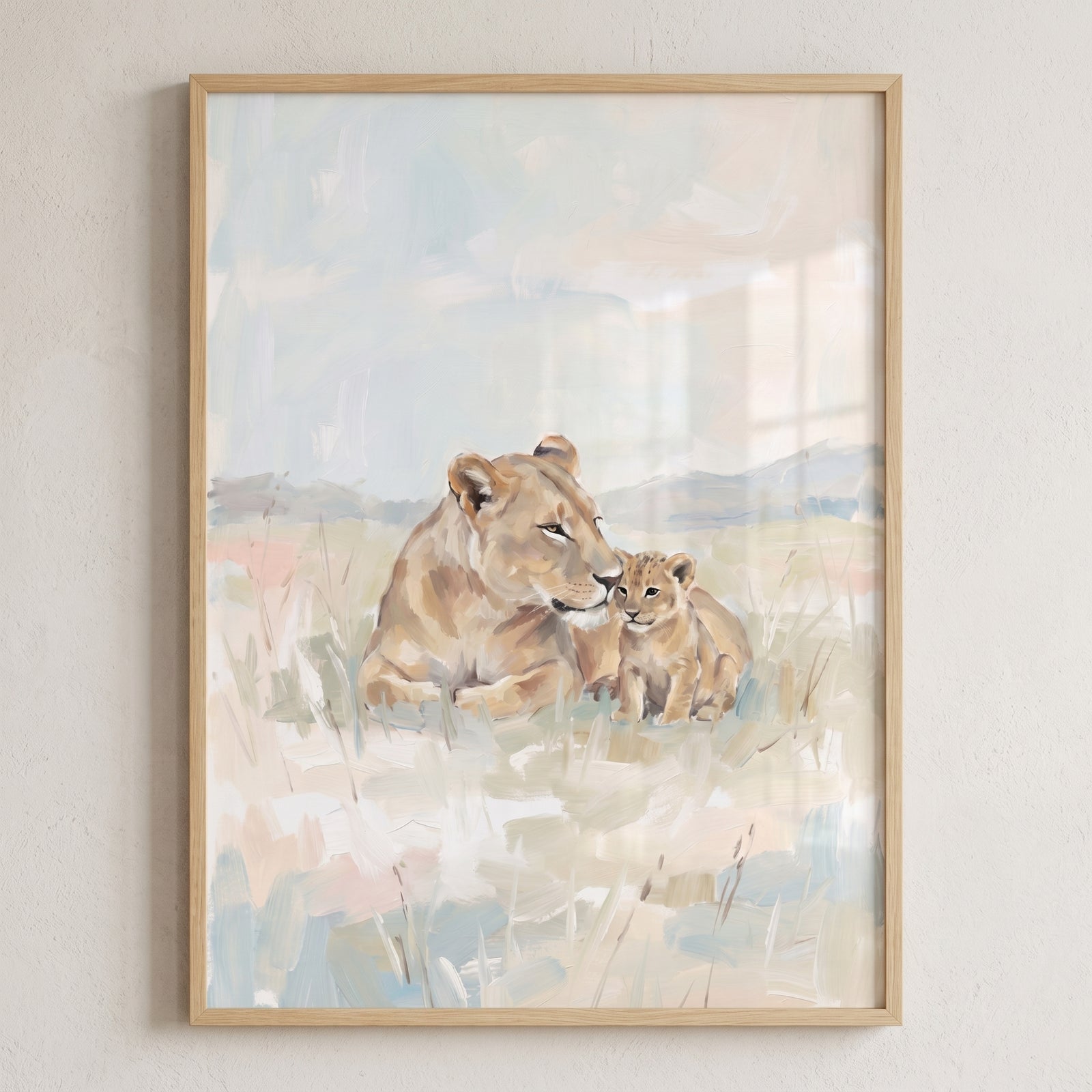 Framed pastel lioness and cub lion wall art depicts a mother lion and her cub resting in a soft, muted grassy field.
