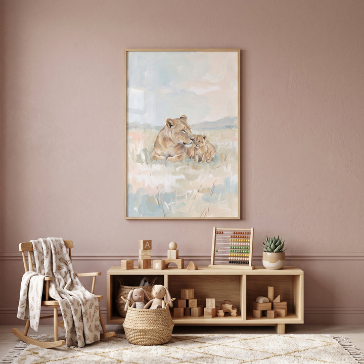 Framed pastel lioness and cub lion wall art hangs in a mauve nursery above a wooden toy shelf and rocking chair.