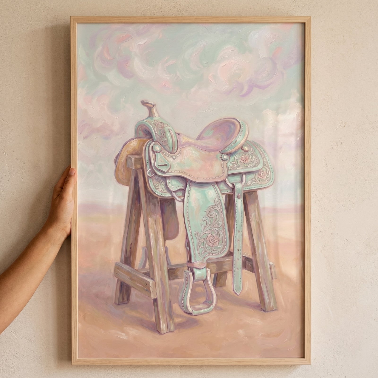 Pastel mint green saddle wall art featuring a floral western saddle on a wooden stand in a soft desert landscape.